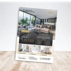 a real estate flyer is displayed on a wooden floor in front of a white wall