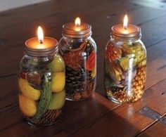 three mason jars filled with different types of fruit and veggies on a table