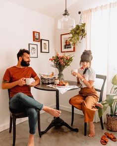 two people sitting at a table eating food