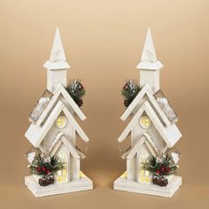 This Decorative Church Sculpture brings a village-like charm to your living room holiday ensemble. Made from fir wood, this decoration shows off a church steeple shape with molded accents, burlap details and cut-out doors and windows for a homey touch.Clusters of evergreen needles, pine cones and holly berries add a Christmastime touch, while battery-operated lights in the interior provide a warm, welcoming glow that's just right for your holiday village display. 1 count package Available in 2 s Christmas Tree Bucket, Holiday Village Display, Guys Gifts, Lodge Lighting, Gabled Roof, Christmas Tree Village, Christmas Village Sets, Christmas Door Wreaths, Fresh Christmas Trees