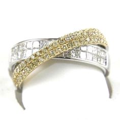 two tone gold and silver ring with white diamonds on it's sides, set against a white background