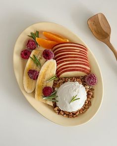 a white plate topped with fruit and nuts