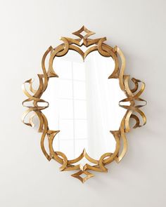 an ornate gold mirror hanging on the wall