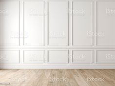 an empty room with white walls and wooden floors stock photo