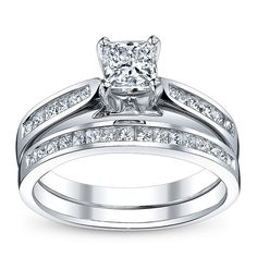 a wedding ring set with a princess cut diamond in the center and side stones on each band