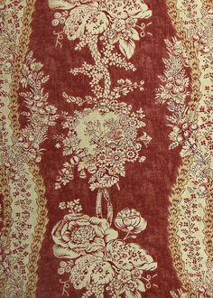 a red and white floral design on fabric