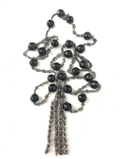 "Antique Cut Steel & Whitby Jet Tassel Necklace Lovely antique cut steel and jet beaded necklace. The cut steel beads are in overall good condition not perfect but there are some beads that have rusted a bit. Also the necklace is very old and needs to be restrung. There is an area at the top of the necklace where the string has broken and some beads have come off and the twist design is gone. From this area only two of the beads are in the bag with the necklace. The necklace is 28\" long not Evening Costume Jewelry Necklace With Faceted Beads, Antique Beaded Evening Necklace, Antique Beaded Necklaces For Evening, Antique Beaded Evening Necklaces, Antique Beaded Necklace For Evening, Vintage Black Bead Necklaces For Evening, Vintage Black Beads Necklace For Evening, Vintage Black Beaded Necklace For Evening, Vintage Black Lariat Jewelry