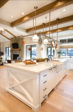 a large open kitchen with an island in the middle and lots of windows on both sides