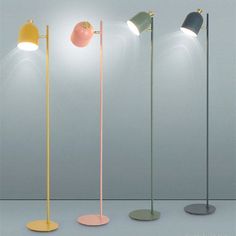 four different colored floor lamps with one light on the top and one on the bottom