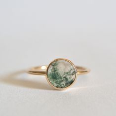 Stunning natural moss agate ring. 8mm moss agate gemstone. This natural stone is clear to milky with beautiful green filaments that resemble moss. 1.4mm smooth band. Polished for a beautiful shine finish. *MATERIAL OPTIONS- -14k Solid (Yellow) Gold -14k Solid Rose Gold -14k Solid White Gold Made to order in your size. Sizes in drop down box are U.S. ring size.  I really want you to be happy with your purchase. If you have any questions or concerns please just let me know:) Minimal Engagement Rings, Hippie Engagement Rings, Hippie Wedding Ring, Agate Engagement Rings, Gold Moss Agate Ring, Moss Agate Wedding Ring, Moosachat Ring, Moss Ring, Minimal Engagement Ring