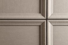 the top part of a metal cabinet door with four square panels on it's sides