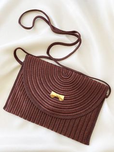 Designer: Nina Ricci Material: Polyester and goldplated metal Colour: Brown Hardware: Gold Condition: Mint condition Highth: 15 cm. Width: 22 cm. Depth: 1 cm. Elegant Brown Woven Shoulder Bag, Formal Brown Woven Bag, Formal Brown Woven Bags, Vintage Brown Rectangular Evening Bag, Vintage Brown Woven Bag, Brown Vintage Woven Shoulder Bag, Vintage Brown Woven Shoulder Bag, Nina Ricci Vintage, Vintage Silk Scarf