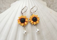 Featuring Hand sculpted Red Yellow Sunflower Earrings. Perfect for Sunflower wedding theme, or sunflower jewelry collection. All Sunflower collection: https://www.etsy.com/shop/MorningHeirloom?ref=seller-platform-mcnav&search_query=sunflower Details: - Sunflower Flower size is approximately 17-18mm. - Glued on Filigree. - 6mm white Swarovski Pearls . Cream available. - The entire length is approximately 4cm. - Metal Finish available in Silver Plated, Gold plated, antiqued brass and Rose Gold White Flower-shaped Jewelry With Sunflower Design, White Flower Jewelry With Sunflower Design, White Sunflower Design Flower Jewelry, Wedding Jewelry With Sunflower Design, Elegant Sunflower Design Flower Earrings, Sunflower Design Jewelry For Anniversary, Elegant Sunflower Design Flower Earrings For Gift, Sunflower Design Flower Jewelry For Anniversary, Yellow Flower-shaped Jewelry With 3d Flowers