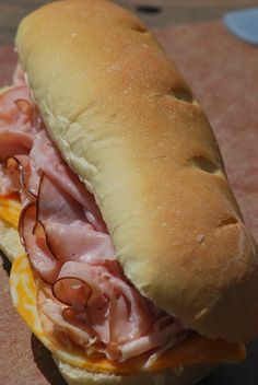 a ham and cheese sandwich sitting on top of a table