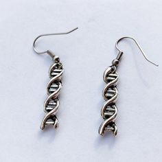 DNA pendant earrings minimalist style gift for her. A minimalist style of this earrings allows to put them with any look on any occasions : Party, Christmas, Birthday, Mother day, Graduation. This cabochon earrings are unique gift for women. You can find more products in my shop : https://www.etsy.com/shop/LorredJewelry?ref=seller-platform-mcnav .The product is sent after 1 - 2 buisiness days.Shipping times :1 week in France.1-2 weeks in Europe.2 weeks in USA and Canada.2 - 3 weeks for the rest Trendy Silver Birthday Jewelry, White Metal Jewelry For Birthday, Metal Earrings Gift For Her, Nickel Free Earrings For Mother's Day Gift, Nickel-free Earrings For Mother's Day Gift, Nickel-free Earrings Gift For Mother's Day, Trendy Earrings For Mother's Day Gift, Trendy Drop Earrings For Gifts, Trendy Nickel-free Earrings For Mother's Day