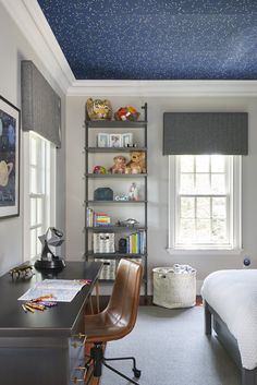 a bedroom with a bed, desk and bookshelf