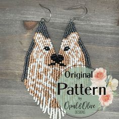 a pair of beaded dog earrings on a wooden background with the words original pattern