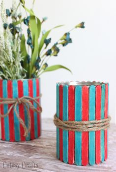 two red, blue and green striped candlesticks tied with twine