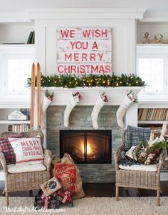 a living room decorated for christmas with stockings on the fireplace and stockings hanging from the mantel