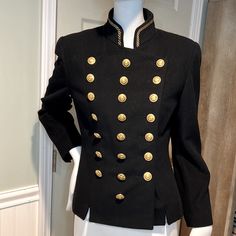 Rare 80s German Luxury Brand Mondi Navy New Virgin Wool Double Breasted Military Jacket With Brass Buttons On Front (A Total Of 22) Small Slits (Front And Back) In Hemline, Smaller Buttons On Cuffs (8 Total). Embroidered Gold Lurex Rope Detail At A Mandarin Collar. Please See All Photos As They Tell The Story. Worn By Model Christy Turlington And A Favorite Brand Of Princess Diana Of Whales. When You Wear It You Get The Feeling Of Royalty As It’s So Beautifully Made And Finished. Excellent Pre-Loved Condition - Like New. European Size 36 Shown On My Size 2/4 Mannequin Measured Flat, Pit To Pit 18 1/2”, Waist 15 1/2” Back Center Top Of Collar To Hemline 25” Measured In Front Bottom Fitted Spring Outerwear With Gold Buttons, Fall Blazer With Epaulettes And Long Sleeves, Fitted Fall Outerwear With Gold Buttons, Vintage Stand Collar Blazer For Work, Tailored Long Sleeve Outerwear With Gold Buttons, Fitted Winter Blazer With Gold Buttons, Vintage Blazer With Stand Collar For Work, Fitted Fall Blazer With Epaulettes, Tailored Winter Outerwear With Gold Buttons