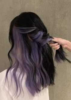 a woman with long black and purple hair