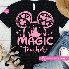 a black shirt with pink minnie mouse ears and the words, magic teacher on it