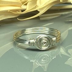 "Handmade Dainty Swirl Sterling Silver, Yellow or Rose Gold Filled Wire Wire Wrapped Ring; Custom Made to Size *This dainty swirl wire wrapped ring is handmade with an approximately 8mm in diameter silver swirl in your choice of wire. *This ring (as well as all the others in my shop) is custom made to any size from 4 to 14 including half and quarter sizes!  DIRECTIONS FOR CHECKOUT To checkout, please select the SIZE of the ring and your choice of BAND COLOR/WIRE from the drop down menus.     Ban Wire Wrapped Ring, Wire Ring, Diy Wire Jewelry, Wire Rings, Argentium Silver, Wire Wrapped Rings, Wrap Rings, Ring Sterling Silver, Silver Rose Gold