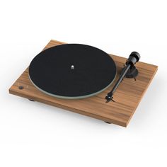 the turntable is made out of wood and has a black vinyl cover on it