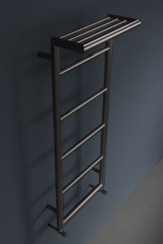 an image of a towel rack in the corner of a room with shadows on the wall