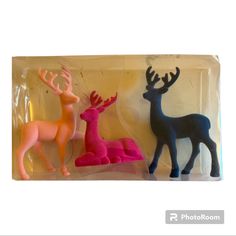 two plastic deer figurines sitting on top of each other