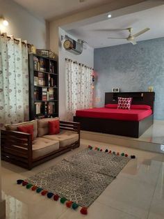 a living room filled with furniture and a red blanket on top of a white floor