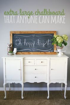 a chalkboard on top of a white dresser next to a sign that says, extra large chalkboard that anyone can make oh happy day