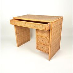 a wooden desk with three drawers on one side and an open drawer on the other