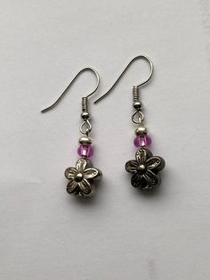 These cute earrings are perfect for springtime and summertime! They are composed of a plastic flower bead and a small pink bead. Earring wire is stainless steel and hypo-allergenic! Nickel-free Flower Earrings For Summer, Pink Metal Earrings For Spring, Pink Flower Metal Earrings, Pink Flower-shaped Metal Earrings, Nickel-free Flower Earrings For Spring, Pink Metal Drop Flower Earrings, Nickel-free Flower Earrings For Jewelry Making In Summer, Nickel-free Flower Earrings For Jewelry Making, Summer Flower Shaped Metal Earrings