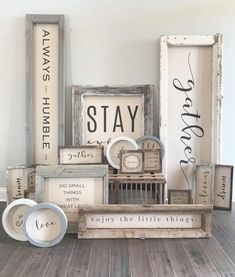 various items are arranged on the floor in front of a wall that says stay, enjoy the little things