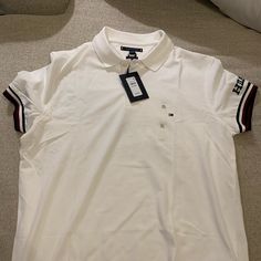 This Is A New Shirt Still With Tags. Casual White Tommy Hilfiger Shirt, White Collared Tommy Hilfiger Top, Fitted Tommy Hilfiger Polo Collar Top, Tommy Hilfiger White Collared Top, Tommy Hilfiger Casual Cotton T-shirt, White Cotton Tommy Hilfiger T-shirt, Tommy Hilfiger Relaxed Fit Cotton T-shirt, Tommy Hilfiger Logo Print Cotton T-shirt, Tommy Hilfiger Shorts