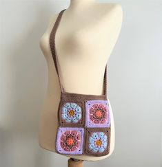 a crocheted bag is on a mannequin's head and torso