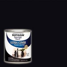 a can of black paint with white trim on the top and bottom, against a dark background