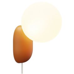 an orange and white lamp sitting on top of a wooden pole next to a light bulb