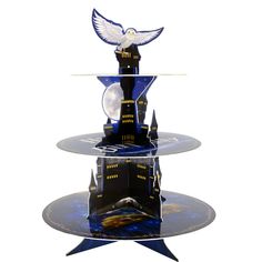 three tiered glass display with an eagle on top