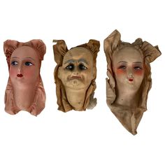 three masks with different shapes and colors on them