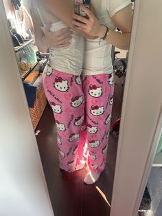 a woman taking a selfie in her hello kitty pajama pants