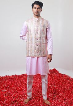 Art Silk Kurta in Baby Pink. This Readymade Chinese Collar Neck and Full Sleeve attire is Enhanced with Fancy Buttons, Mirror Effect, Resham and Sequins Work Available with a Cotton Silk Aligarhi Pant in White and a Faux Georgette Nehru Jacket in Baby Pink Do note: Footwear shown in the image is for presentation purposes only. Half to one inch may vary in measurement. (Slight variation in actual color vs. image is possible) We sell all kinds of menswear. Mens Kurta | Mens Kurta Pajama | Mens She Multicolor Traditional Sets For Spring, Traditional Pink Bandhgala With Chikankari Embroidery, Pink Sets With Dori Work For Transitional Season, Transitional Pink Sets With Dori Work, Transitional Multicolor Floral Embroidery Sets, Traditional Pink Bandhgala With Resham Embroidery, Pink Bandhgala With Chikankari Embroidery For Festive Occasions, Pink Bandhgala With Chikankari Embroidery For Festivals, Festive Pink Sets With Chikankari Embroidery