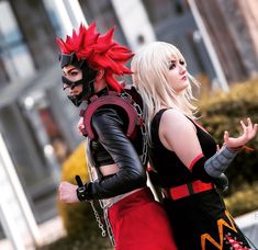 two people dressed in costumes walking down the street