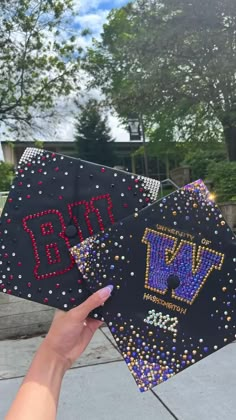 someone is holding up two graduation caps that have beads on them and the words,