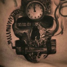 a tattoo with a clock and skull on it