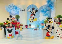 a mickey mouse themed birthday party with balloons