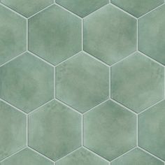 a green tile wall with hexagonal tiles