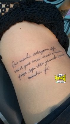 the back of a woman's stomach with a quote written on it