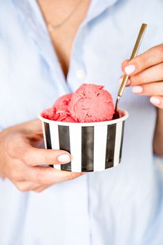 a woman is holding a bowl of ice cream